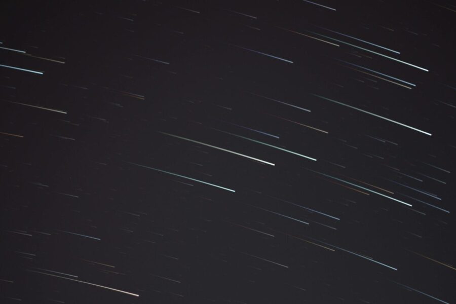 A mesmerizing long exposure photograph capturing streaking stars in the night sky.