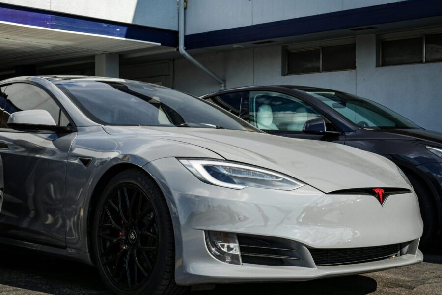Close-up view of a sleek Tesla Model S parked outdoors, showcasing modern electric vehicle design.