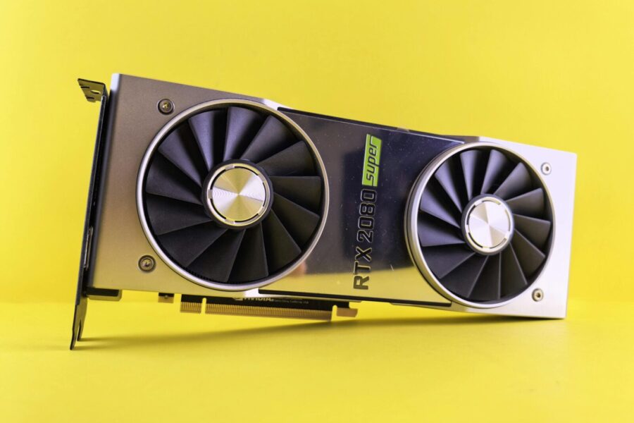 Close-up of a RTX 2080 Super graphics card against a bright yellow backdrop, showcasing high-tech design.