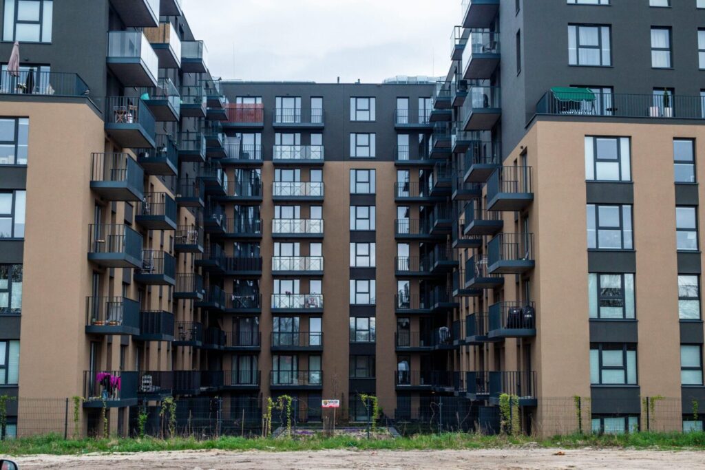 Contemporary apartment building facade with balconies in an urban setting.