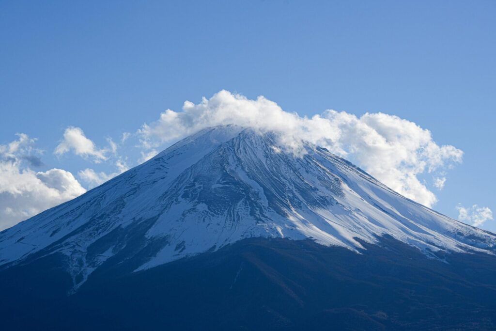 Serene view of snow-capped Mount Fuji under clear blue skies, perfect for nature lovers.