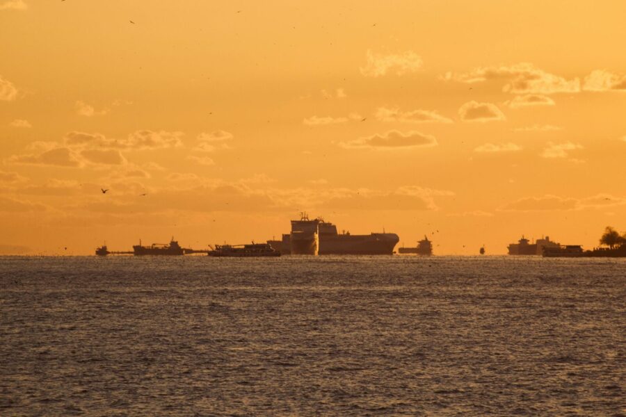 Ships silhouetted against the golden hues of sunset on the Bosphorus Strait.