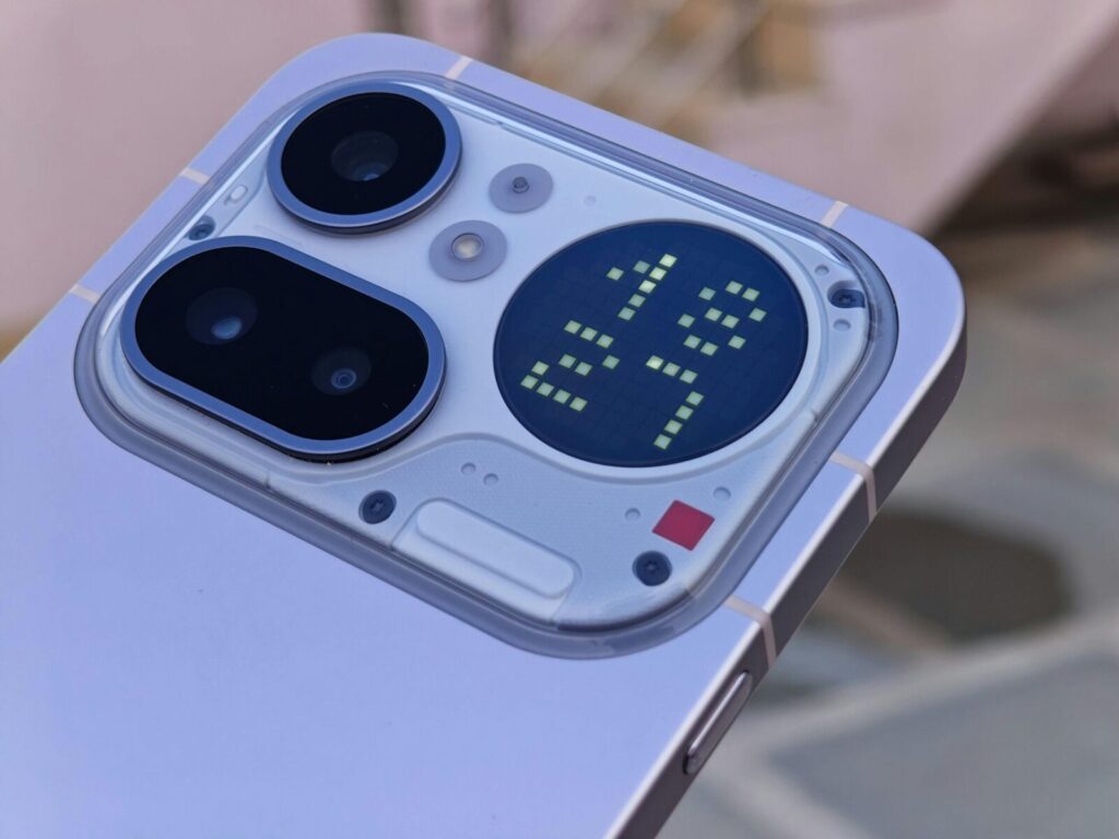 Detailed view of a smart device's camera and modular digital display.