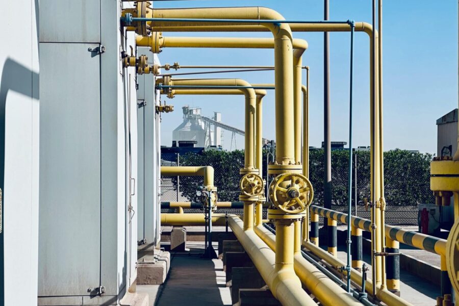 A detailed view of industrial pipelines in a Saudi Arabian factory setting.