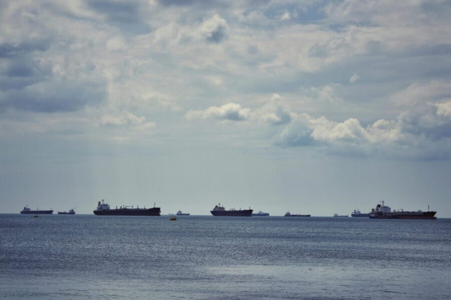 Scenic view of multiple cargo ships anchored on the Bosphorus Strait under a cloudy sky in İstanbul.