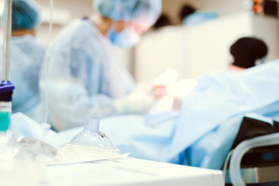 Blurred view of a surgical team in a hospital operating room.