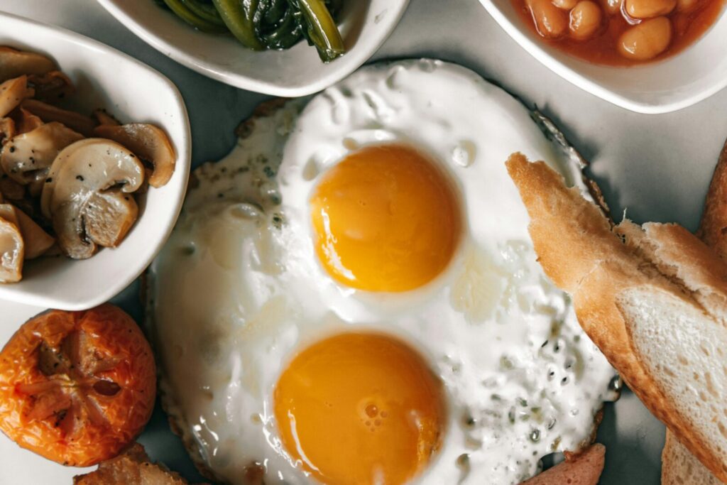 A delectable breakfast spread featuring eggs, bread, and fresh vegetables.