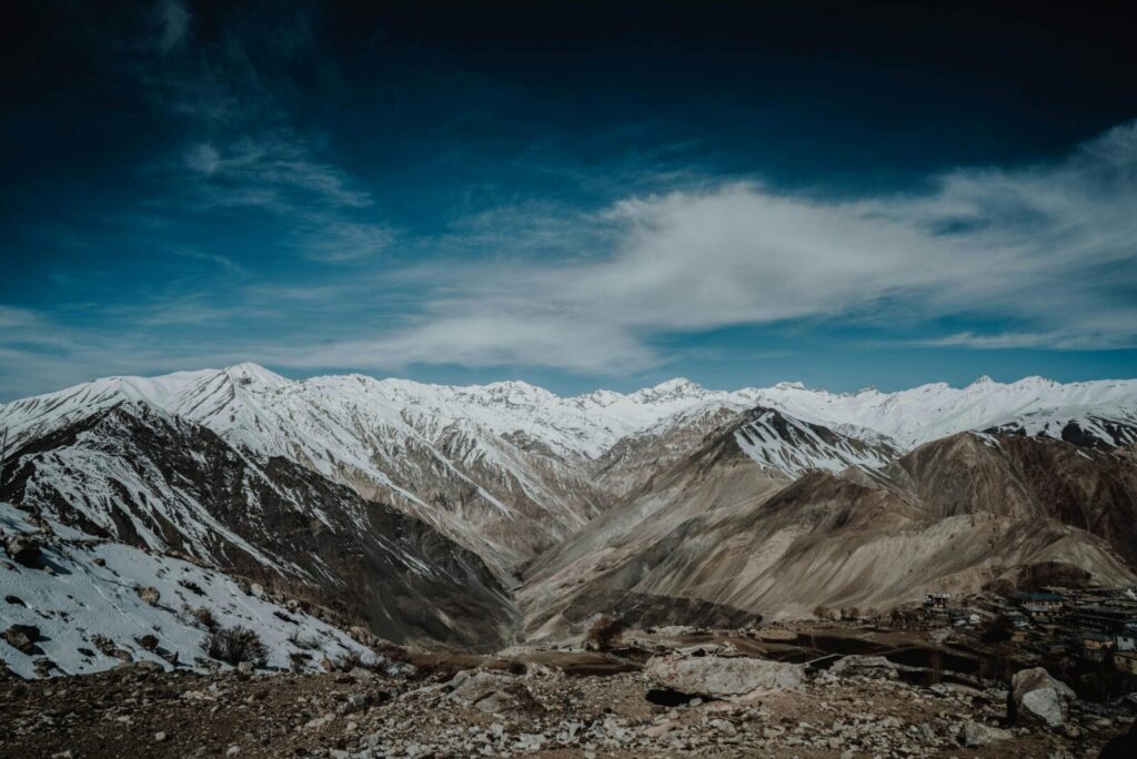 Stunning snowy mountain landscape under a dramatic sky captured outdoors.