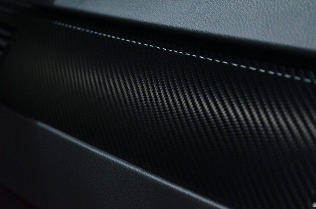 Detailed view of a carbon fiber texture on a car interior showcasing modern design.
