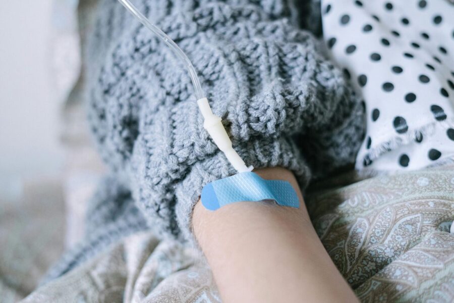 Close-up of a patient receiving intravenous therapy during cancer treatment.