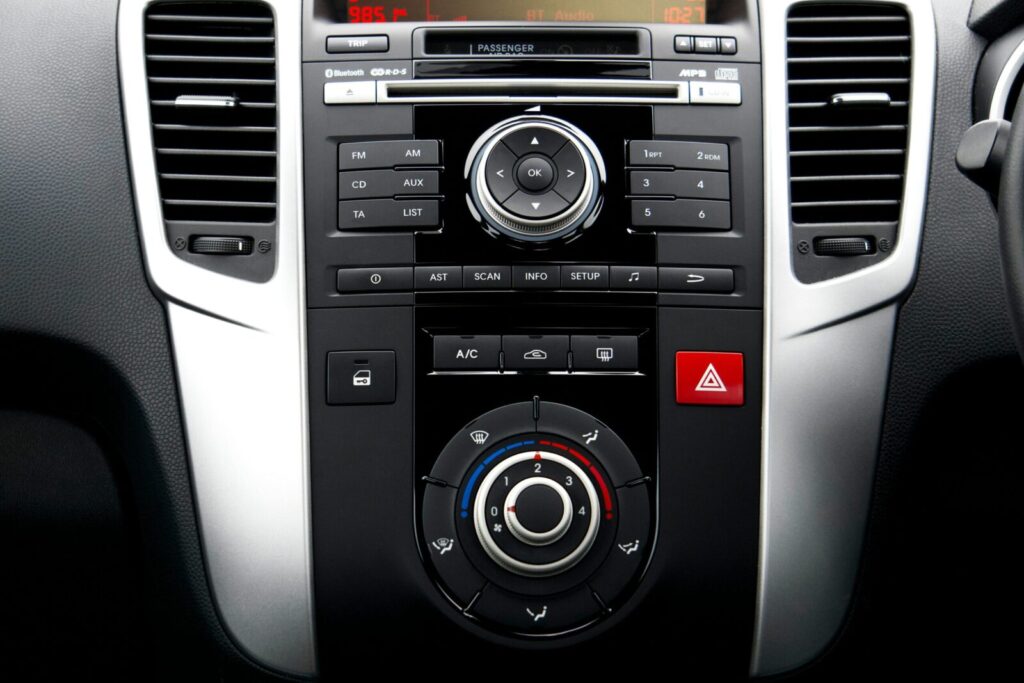 Close-up of a car dashboard with modern controls and technology features.