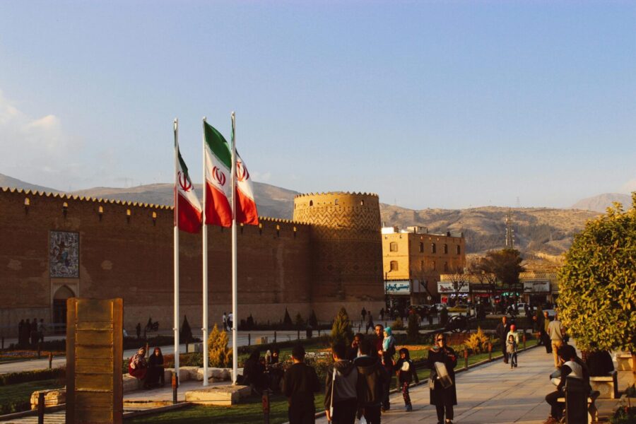 Karim Khan Citadel with Iranian flags in Shiraz, Iran at sunset.