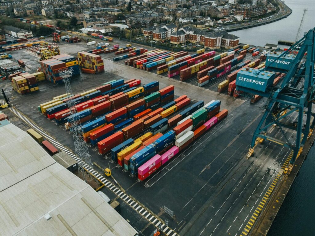 Colorful cargo containers stacked at Clydeport terminal, Scotland, showcasing vibrant logistics scene.