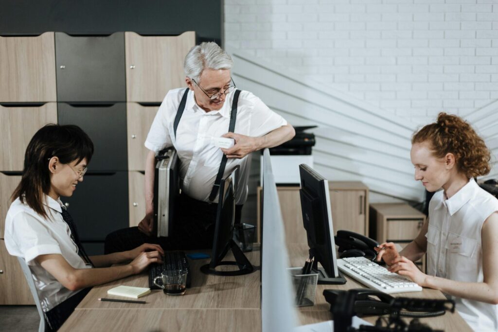 Group of diverse office workers collaborating at their desks. Professional teamwork setting.