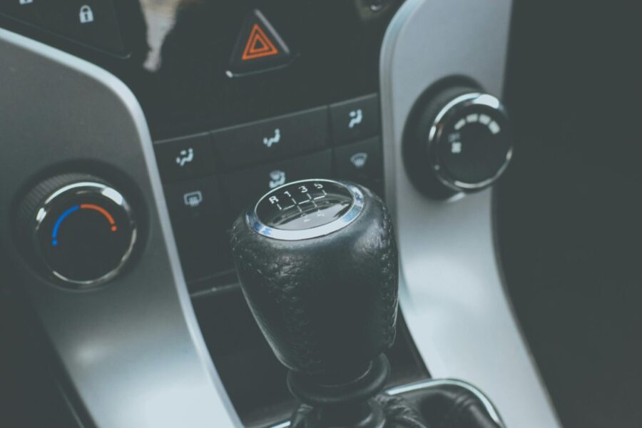 Detailed view of a manual gear shift knob and car console interior.