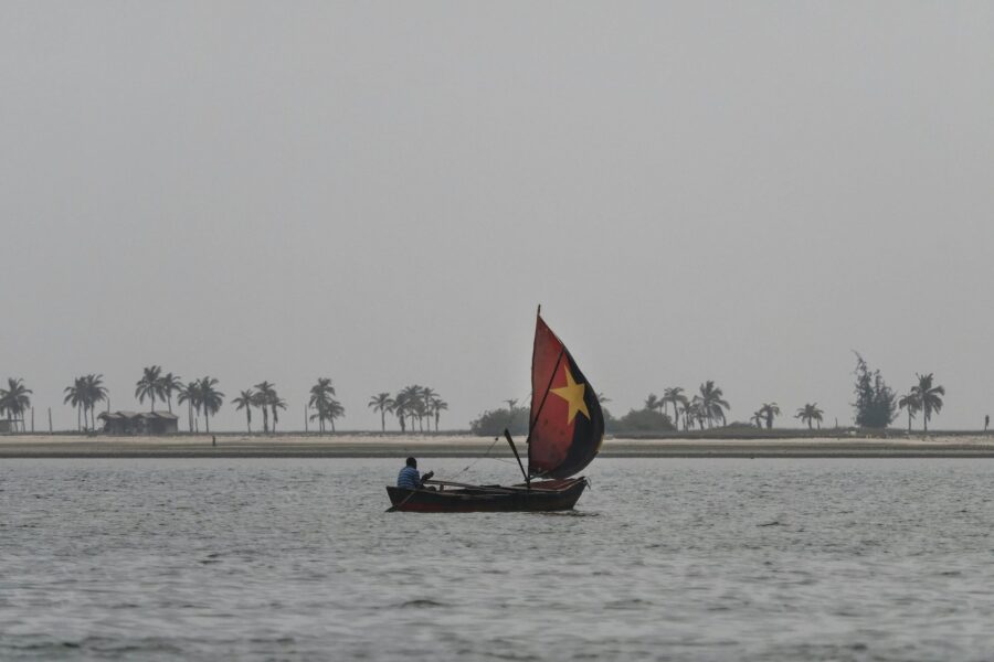man on sailboat on sea during daytime