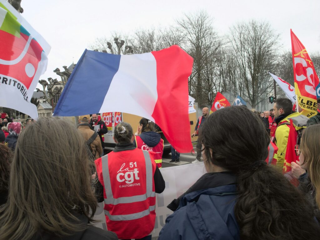 a group of people holding flags and signs