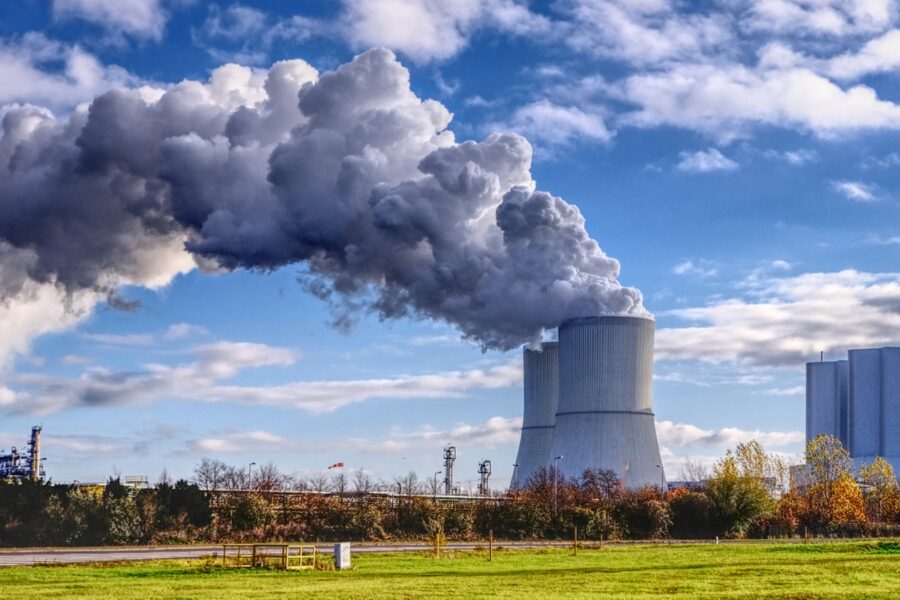 A factory with smoke pouring out of it's stacks