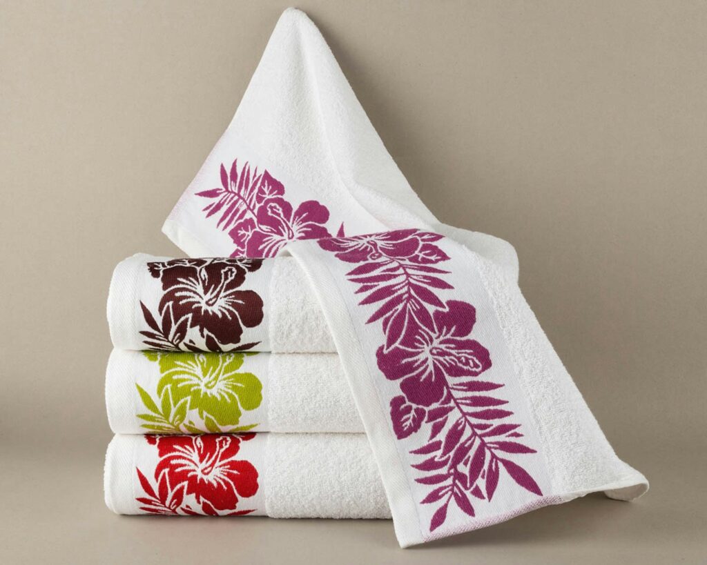 Stack of white towels with floral designs