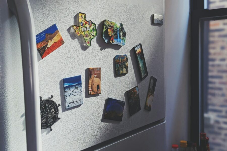 gray top mount refrigerator with stickers