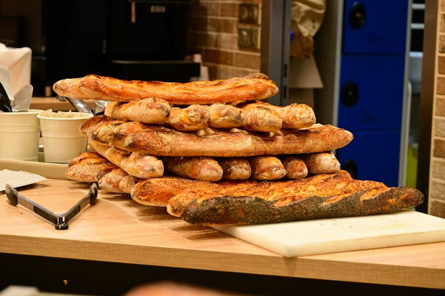A pile of bread sitting on top of a wooden table