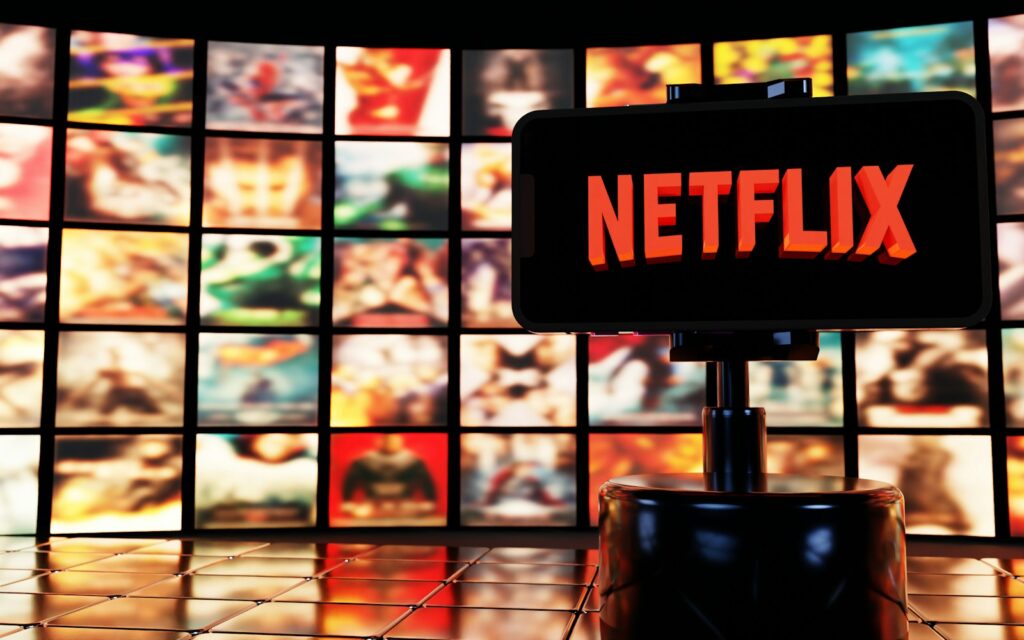 Netflix logo displayed in front of movie posters.