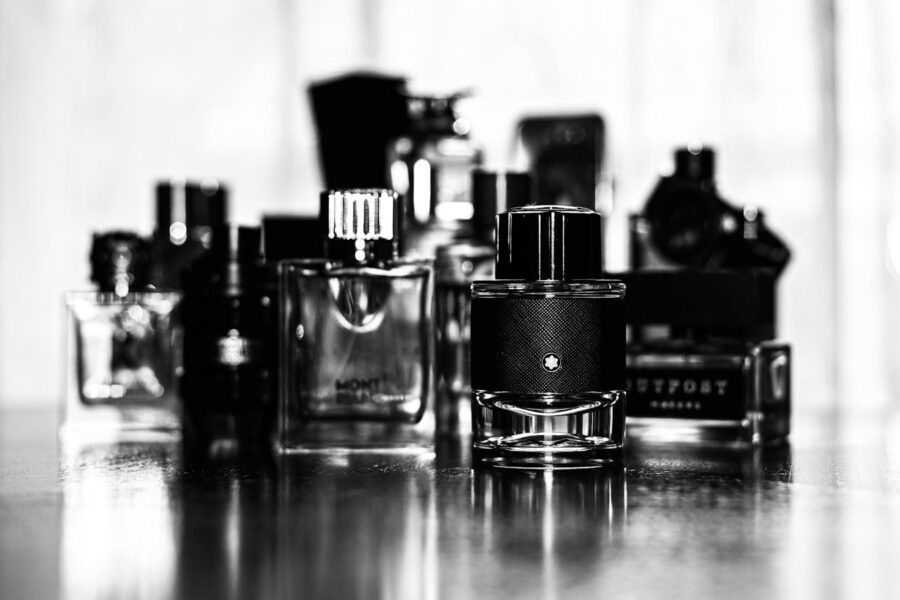 grayscale photo of perfume bottles