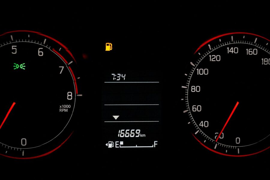Car dashboard with speedometer and fuel gauge.