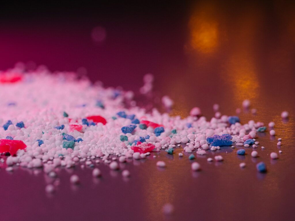 Laundry detergent granules are close-up.