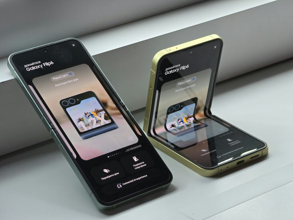 Two cell phones sitting next to each other on a window sill