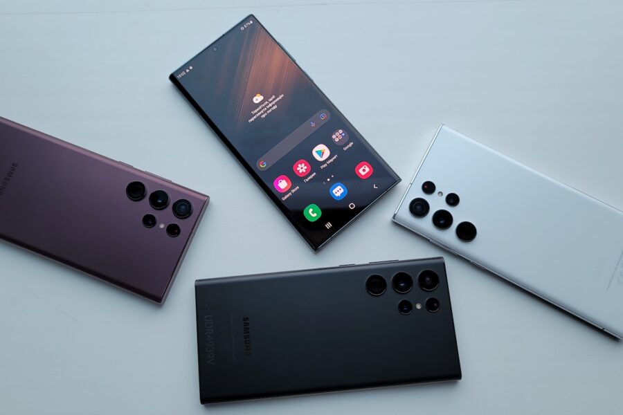 a group of three different cell phones sitting next to each other