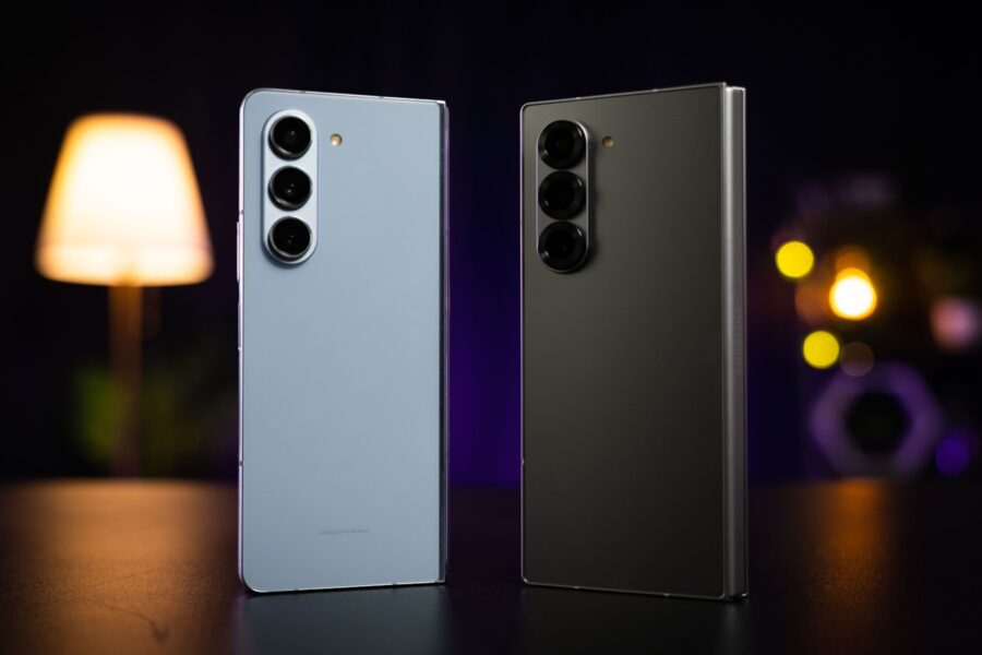 Two cell phones sitting next to each other on a table