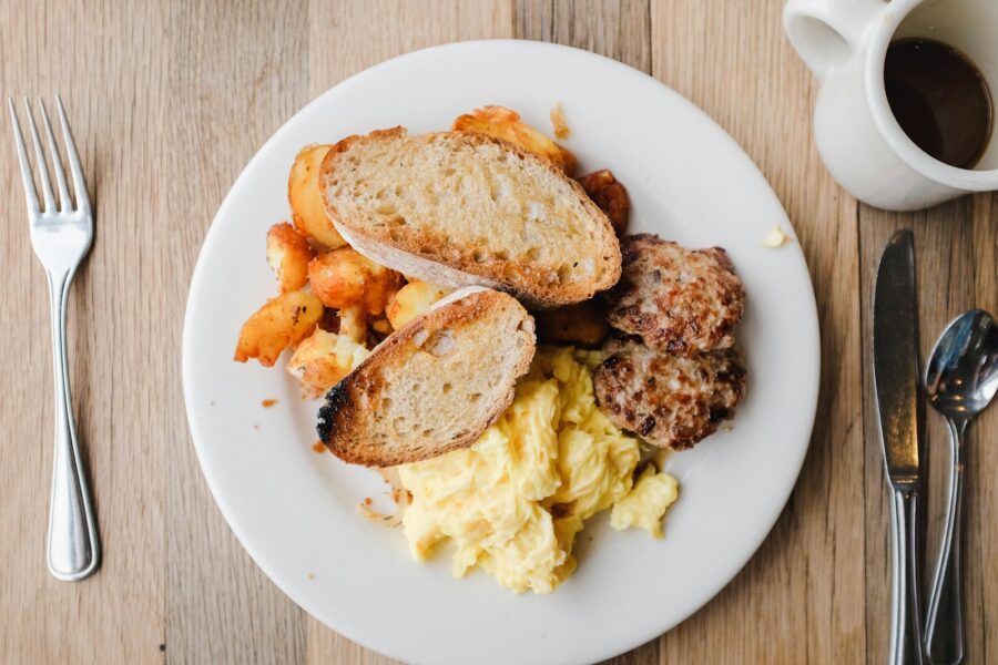 French bread and mashed potato on white ceramic plate