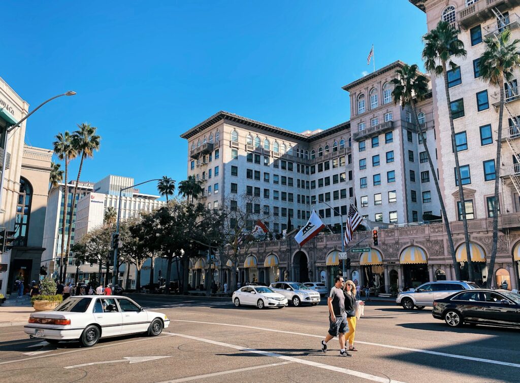 woman in yellow shirt and black shorts walking on sidewalk during daytime