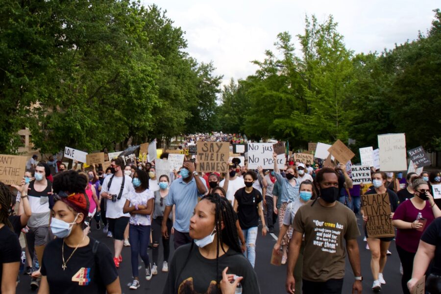 people standing on road during daytime