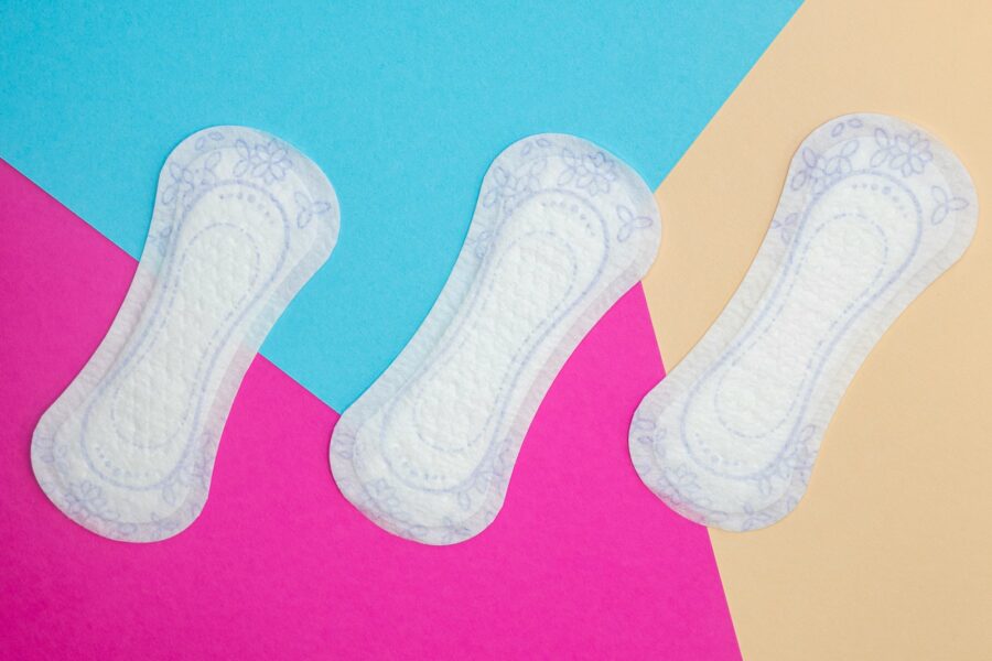a pair of white socks sitting on top of a pink and blue background