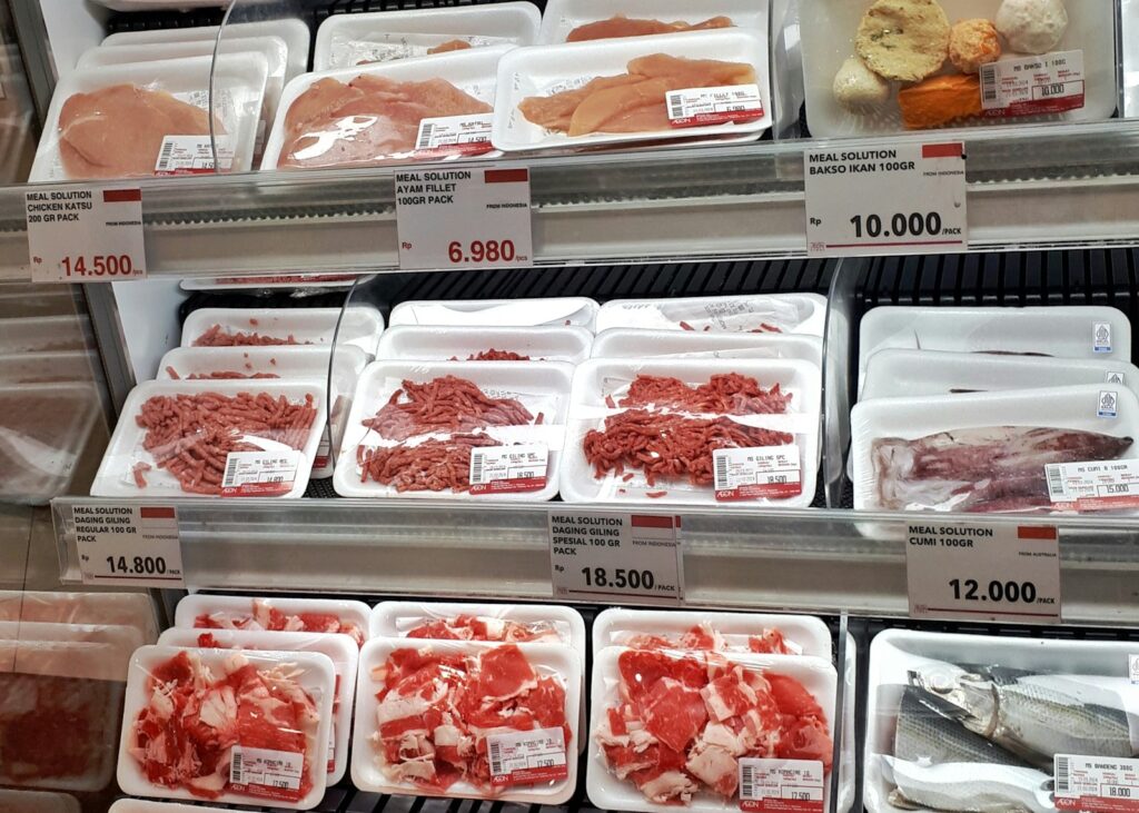 A display case filled with lots of different types of meat