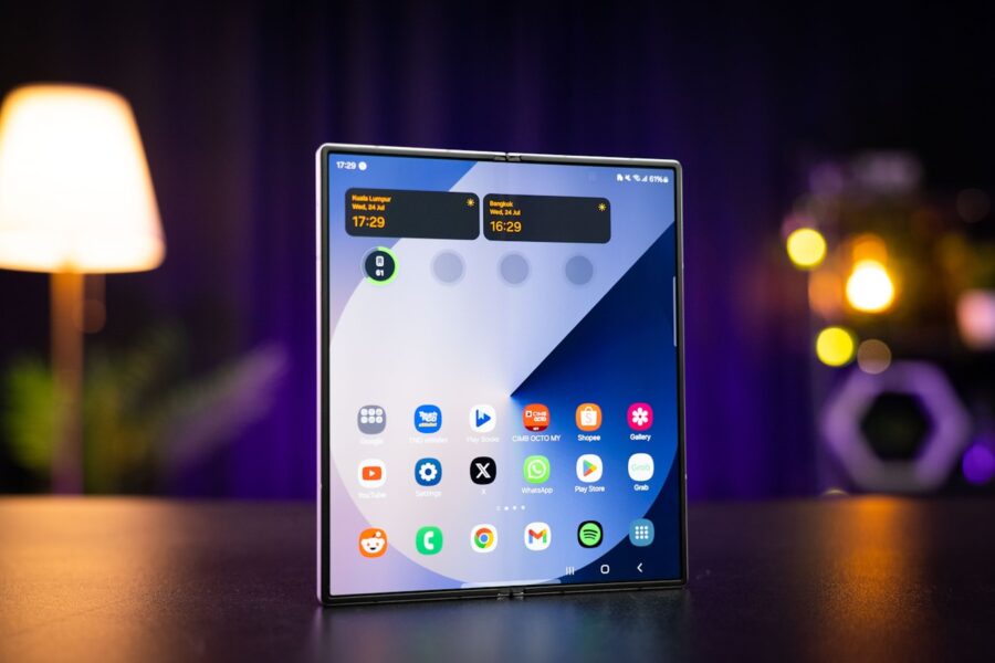 A cell phone sitting on top of a table next to a lamp