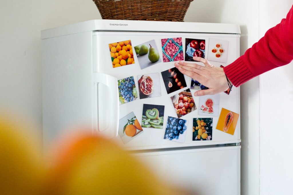 a refrigerator with pictures of fruits and vegetables on it