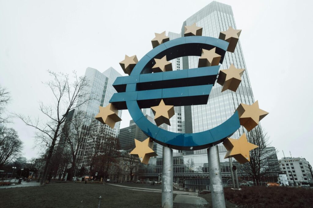 Iconic Euro sculpture in front of skyscrapers in Frankfurt during a winter day.