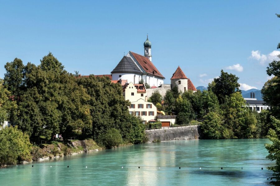 Picturesque town view in Füssen, Germany with a historic church and a river.