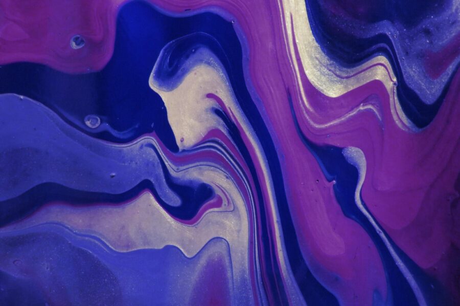 Dynamic abstract artwork featuring blue and purple fluid patterns with elegant swirls and rich textures.