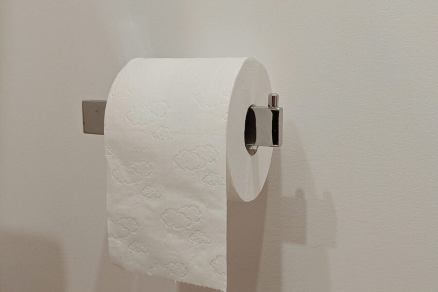 Toilet paper roll on a modern holder in a minimalist bathroom setting.