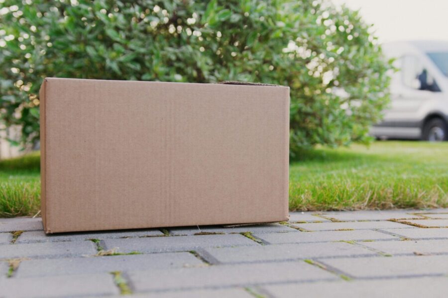 A close-up of a cardboard box on a driveway, ideal for delivery themes.
