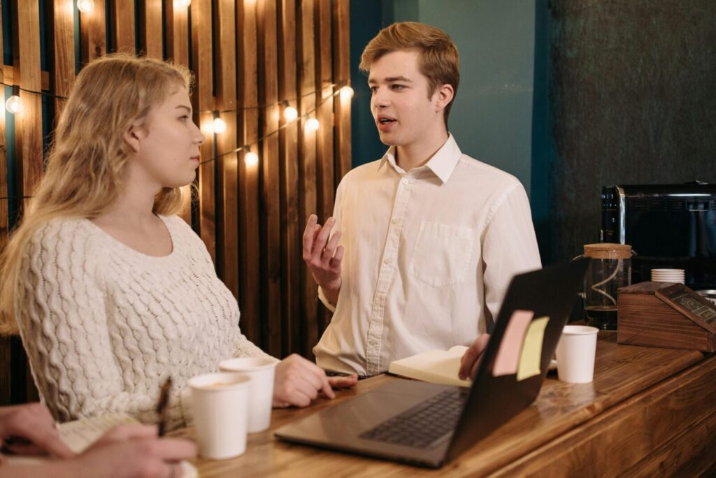 Young professionals having a casual team meeting in a cozy indoor space.