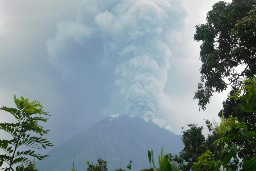 Smoke billows from an erupting volcano in Indonesia, showcasing nature's power.
