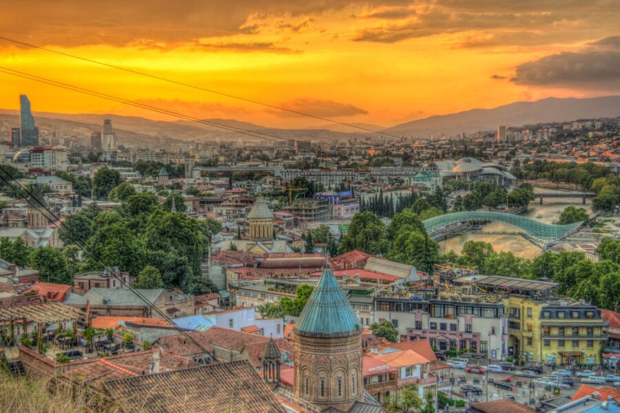 city with high-rise buildings under orange skies