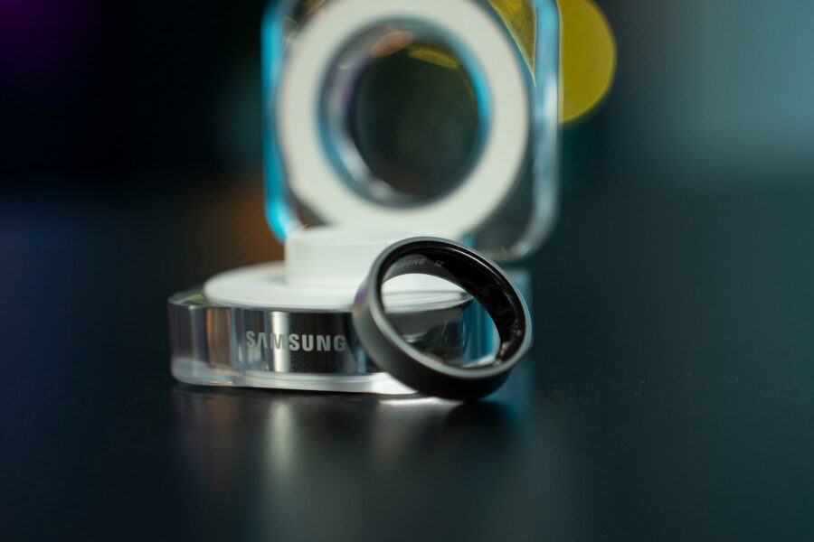 A black samsung ring with its charging dock.