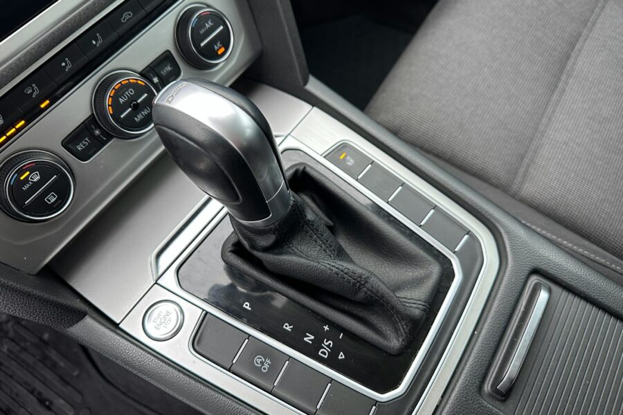 Close-up of an automatic car gear shift and dashboard controls